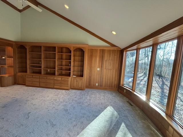 unfurnished living room featuring carpet, ceiling fan, and high vaulted ceiling