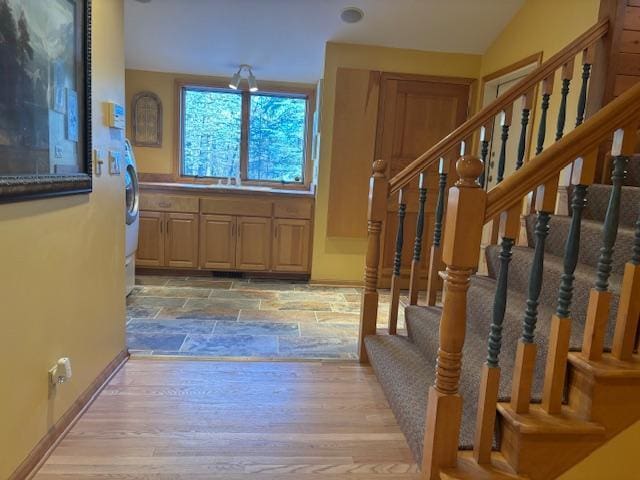 stairway with wood-type flooring and vaulted ceiling