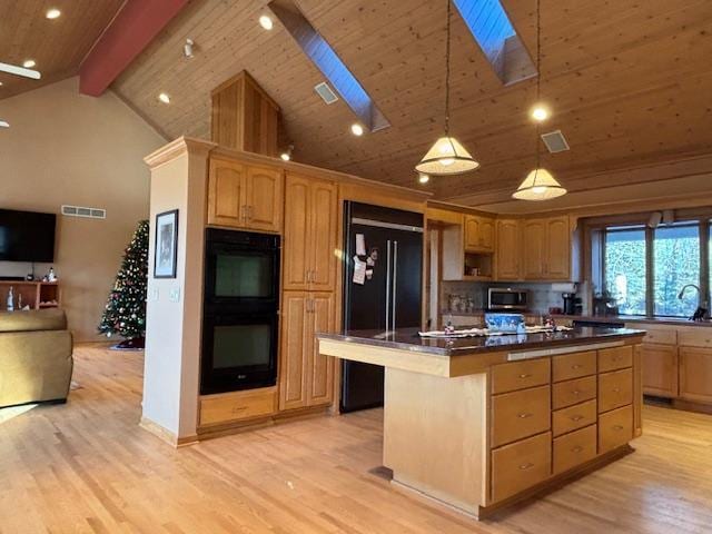 11233 Chisago Blvd, Chisago City, MN 55013 - kitchen featuring black appliances, a skylight, light wood-type flooring, a center island, and dark countertops