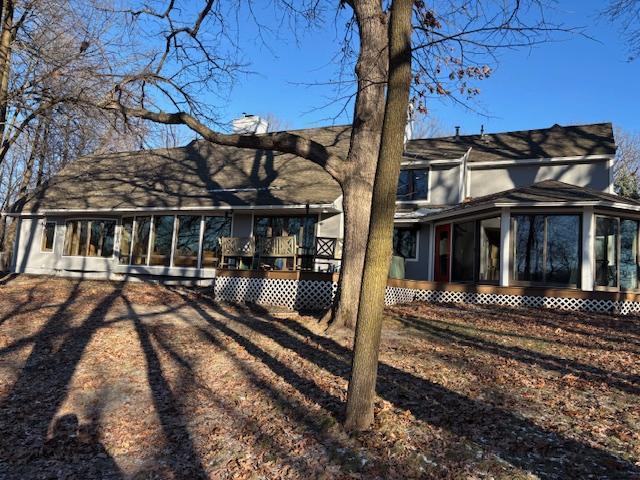 11233 Chisago Blvd, Chisago City, MN 55013 - rear view of property with a sunroom and a chimney