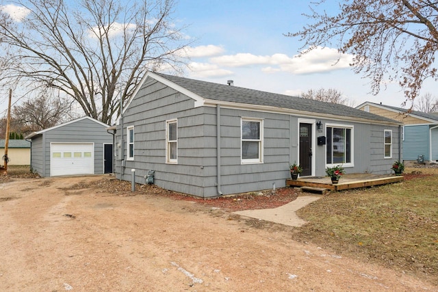 view of front of house featuring a deck, a garage, and an outdoor structure