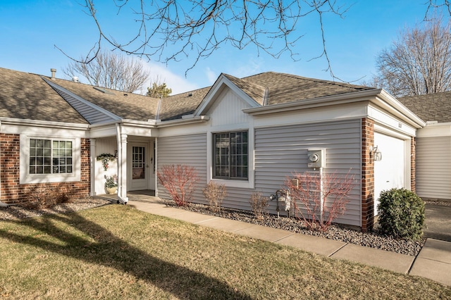 view of front of property featuring a garage and a front yard