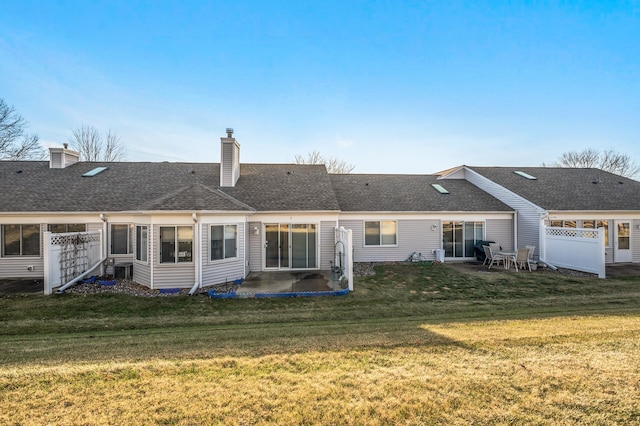 back of house featuring a yard and a patio area