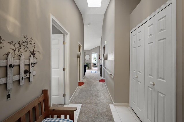 hall featuring light carpet and a skylight