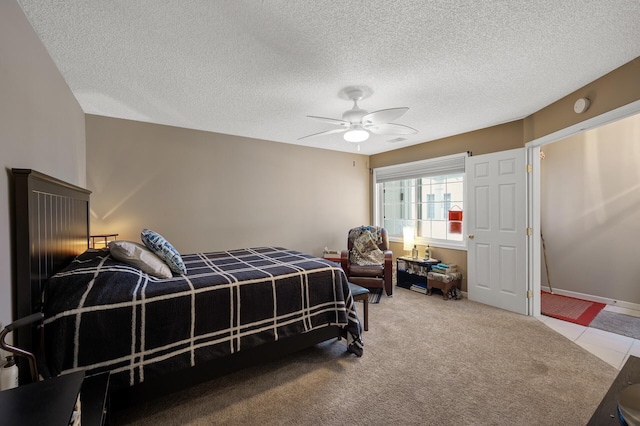 bedroom with a textured ceiling, carpet floors, and ceiling fan