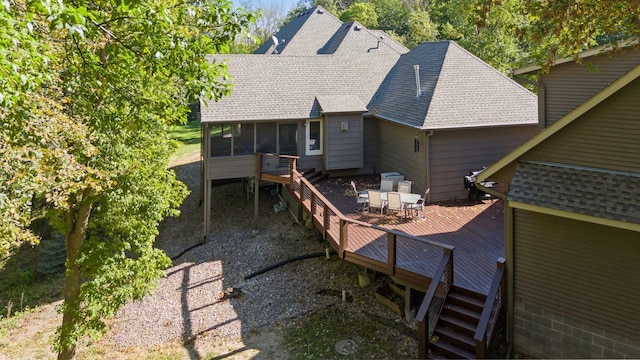 back of house featuring a wooden deck and a sunroom