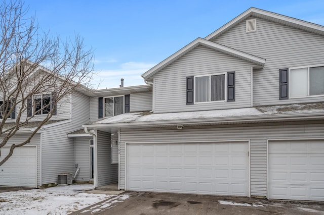 front of property featuring a garage and central air condition unit