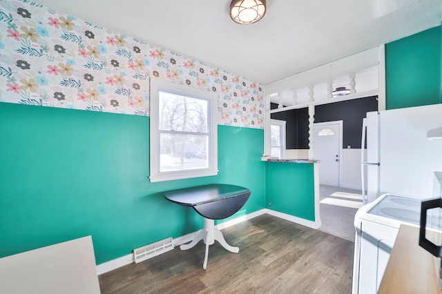 bathroom featuring wood-type flooring and washer / dryer