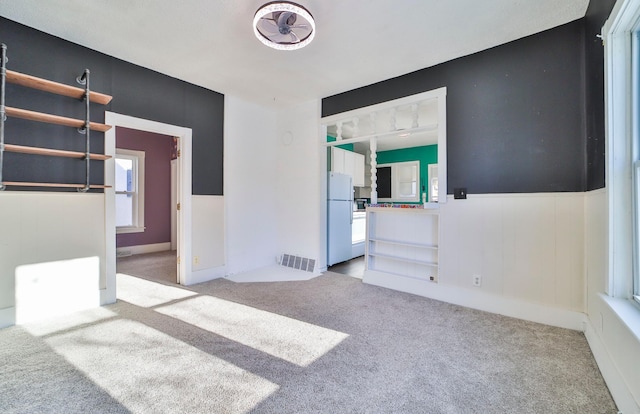 empty room featuring light colored carpet