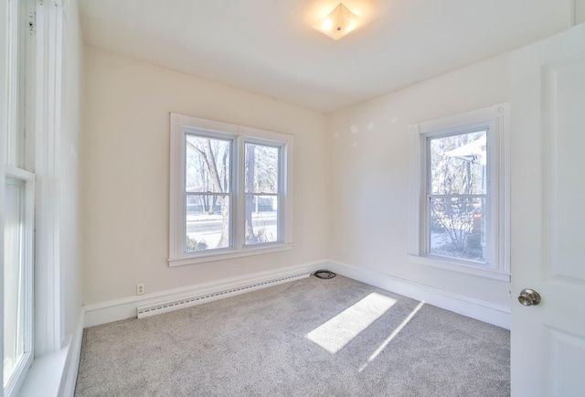 empty room with carpet flooring and a baseboard radiator