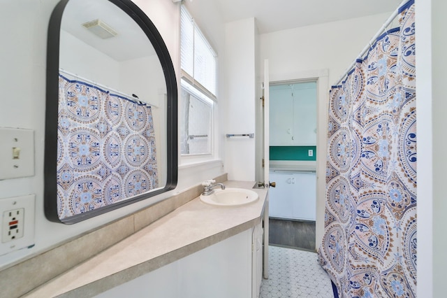 bathroom with tile patterned flooring and vanity