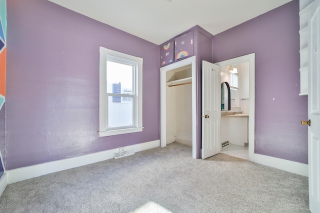 unfurnished bedroom with light carpet and a closet