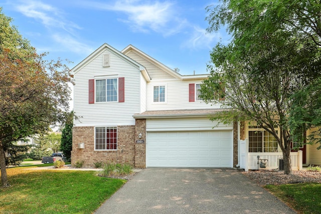 view of property with a front lawn and a garage