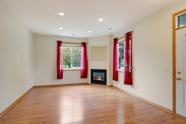 unfurnished living room featuring light wood-type flooring