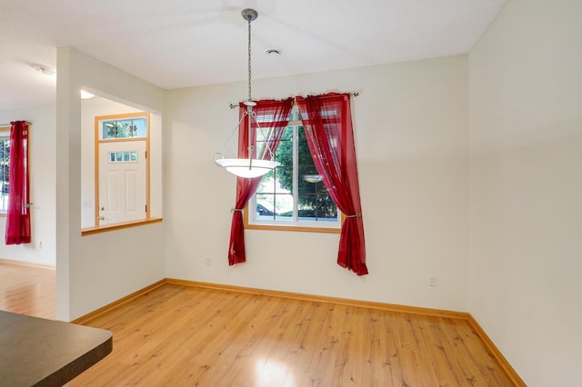 unfurnished dining area with wood-type flooring