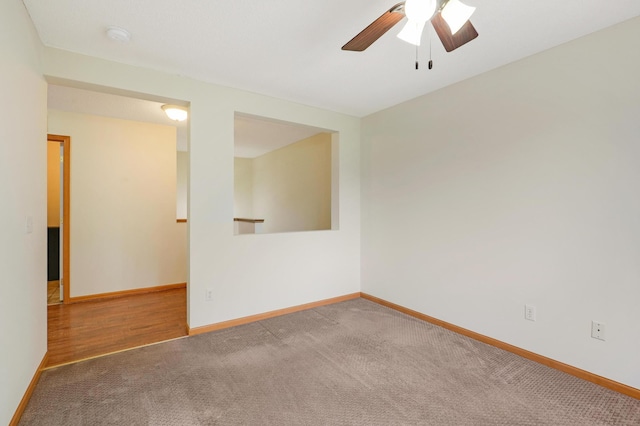 carpeted empty room featuring ceiling fan