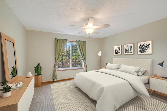 bedroom featuring ceiling fan, light colored carpet, and a textured ceiling