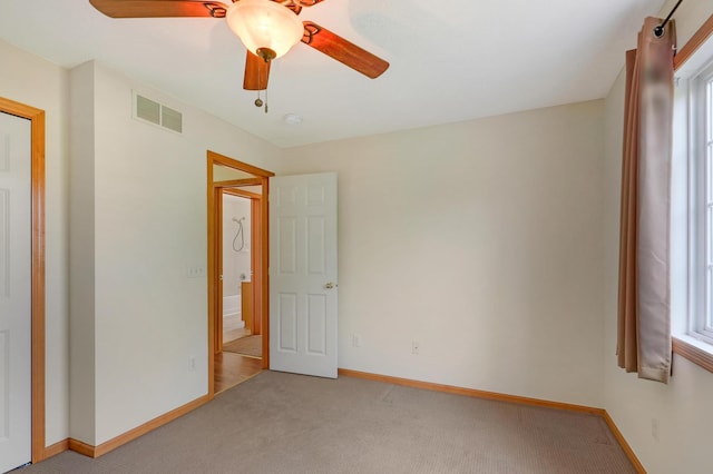 carpeted empty room with ceiling fan