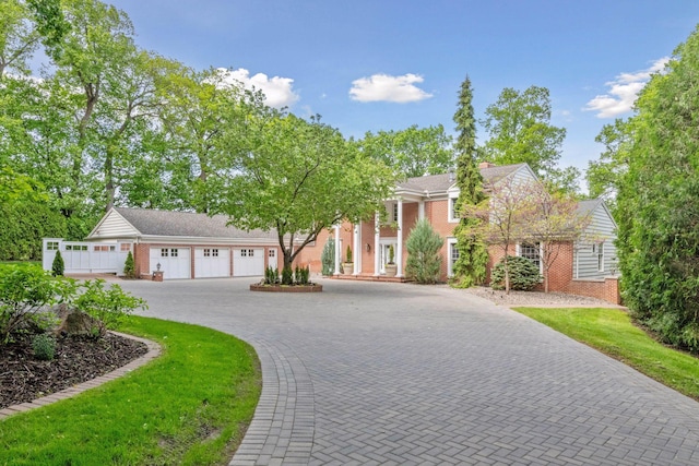 2496 Old Beach Rd, Orono, MN 55391 - neoclassical / greek revival house with decorative driveway, an attached garage, and brick siding