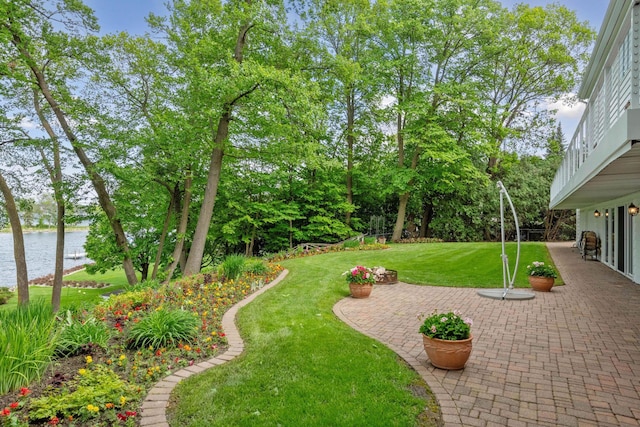 2496 Old Beach Rd, Orono, MN 55391 - view of grassy yard with a water view, a patio, and view of scattered trees