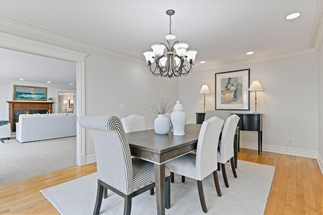 2496 Old Beach Rd, Orono, MN 55391 - dining space with a chandelier, baseboards, recessed lighting, light wood-style floors, and crown molding