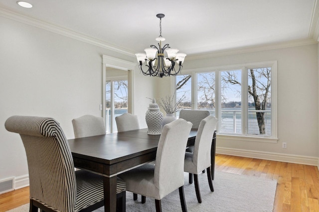 2496 Old Beach Rd, Orono, MN 55391 - dining space with a chandelier, ornamental molding, light wood finished floors, and baseboards