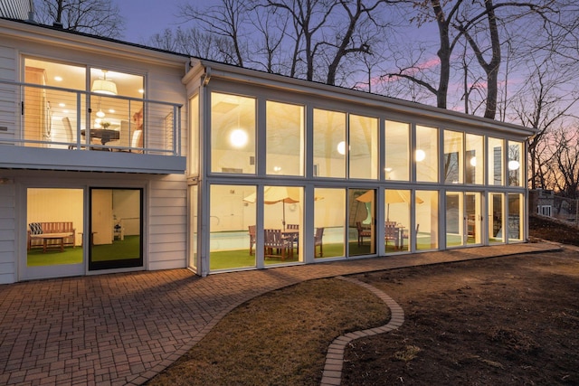 2496 Old Beach Rd, Orono, MN 55391 - rear view of house featuring a sunroom and a patio
