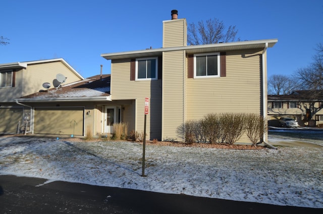 rear view of house with a garage