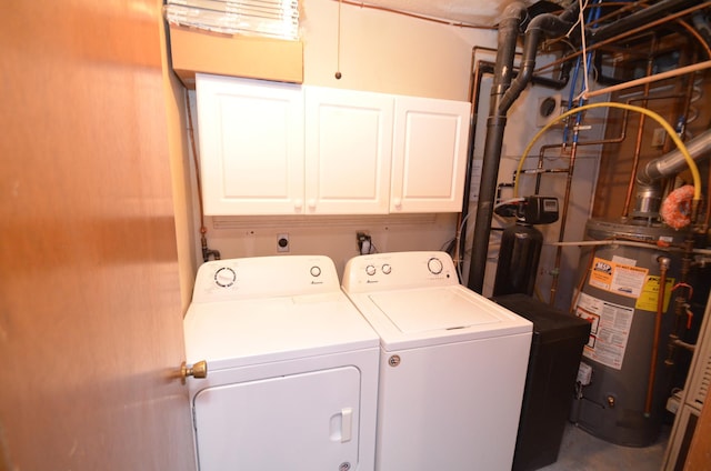 washroom with washing machine and dryer, water heater, and cabinets