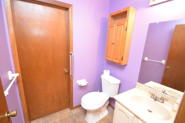 bathroom with tile patterned floors, vanity, and toilet