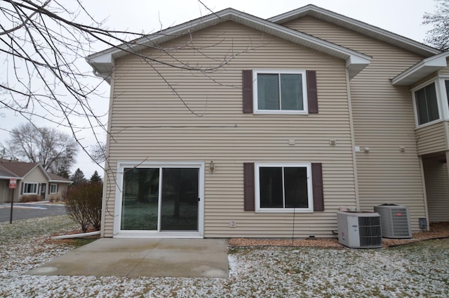 rear view of property with a patio area and central AC