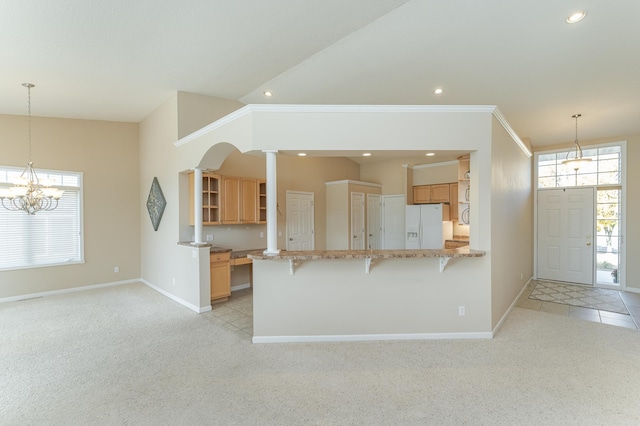 kitchen featuring white refrigerator with ice dispenser, kitchen peninsula, a kitchen bar, light carpet, and ornamental molding