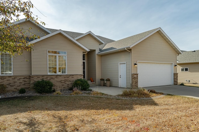 view of front of property with a front lawn and a garage