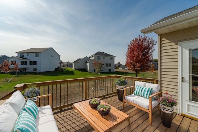 wooden deck featuring an outdoor living space and a lawn