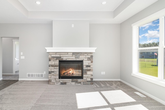 unfurnished living room with a fireplace, plenty of natural light, and carpet floors