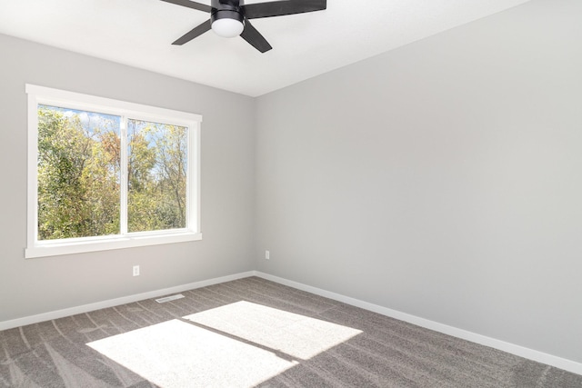 unfurnished room with ceiling fan and carpet floors