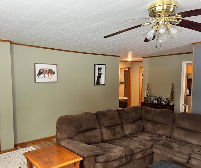 living room with ornamental molding and ceiling fan