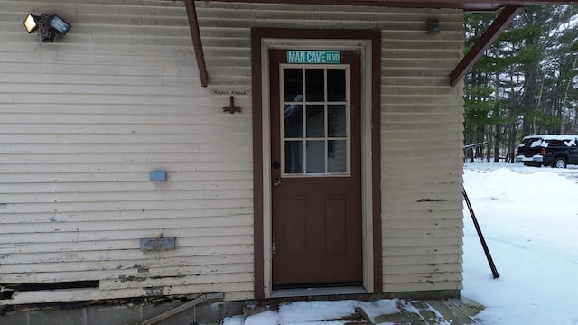 view of snow covered property entrance