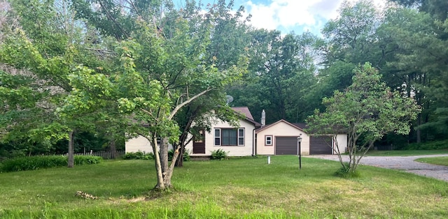 11159 Steamboat Loop NW, Walker, MN 56484 - view of front of property featuring driveway, a front yard, and a garage
