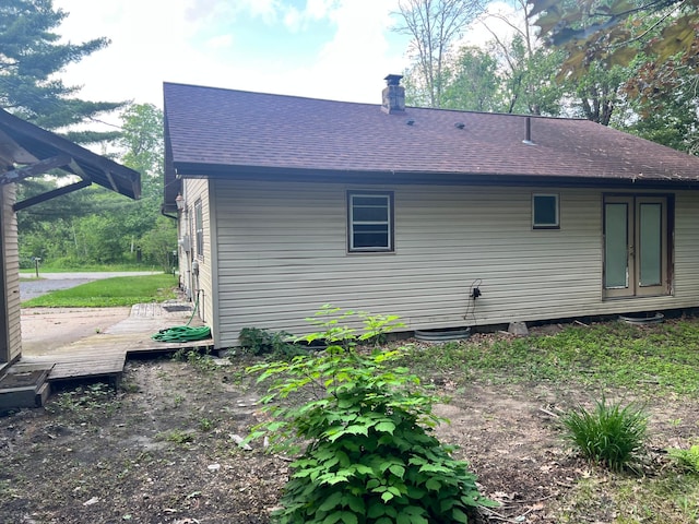 11159 Steamboat Loop NW, Walker, MN 56484 - back of property featuring a shingled roof, a chimney, and a deck