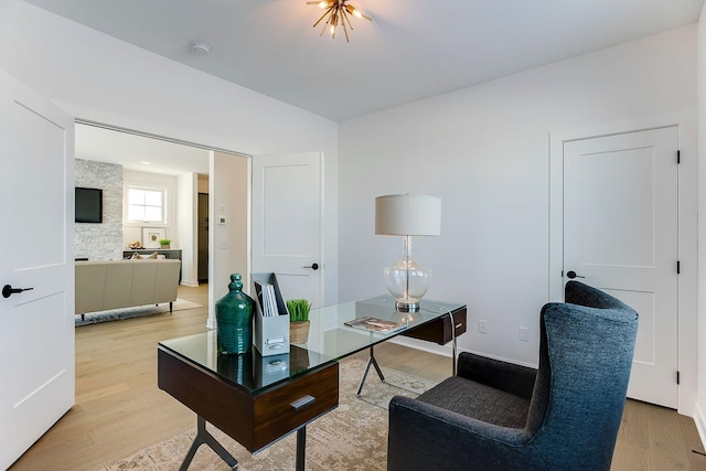 office area with light hardwood / wood-style floors