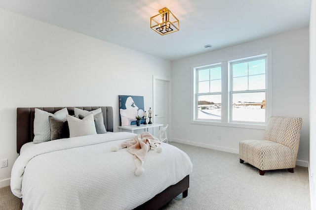 carpeted bedroom with a chandelier