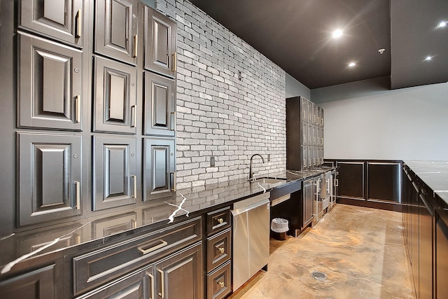 kitchen featuring dishwasher, backsplash, dark stone counters, sink, and dark brown cabinets