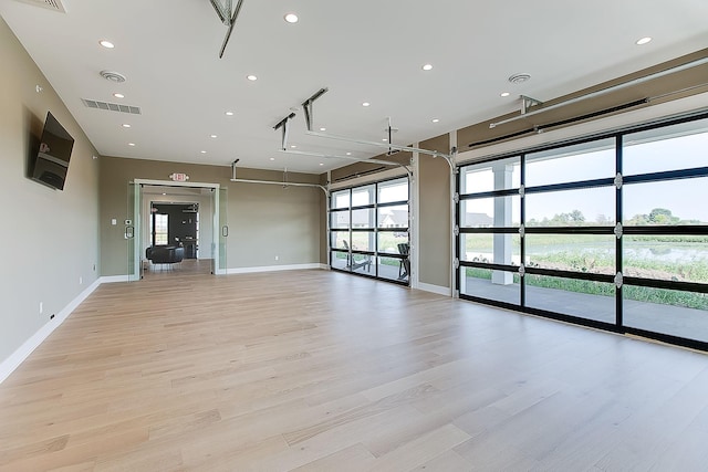 empty room with light hardwood / wood-style flooring