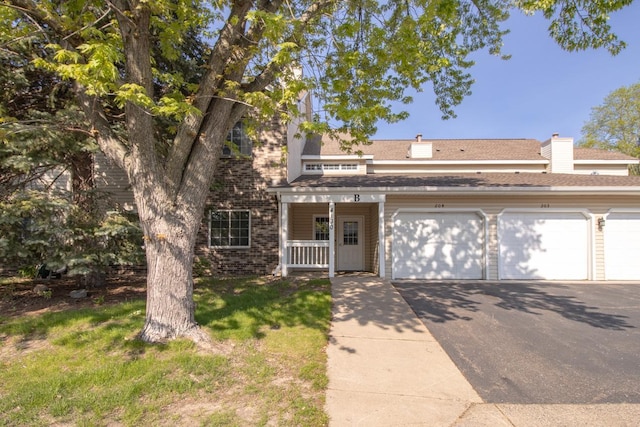 view of front of property with a porch and a garage