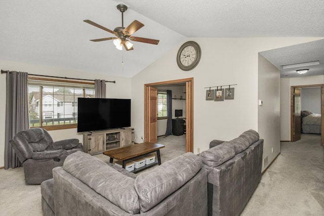 living room featuring light colored carpet, a healthy amount of sunlight, and lofted ceiling