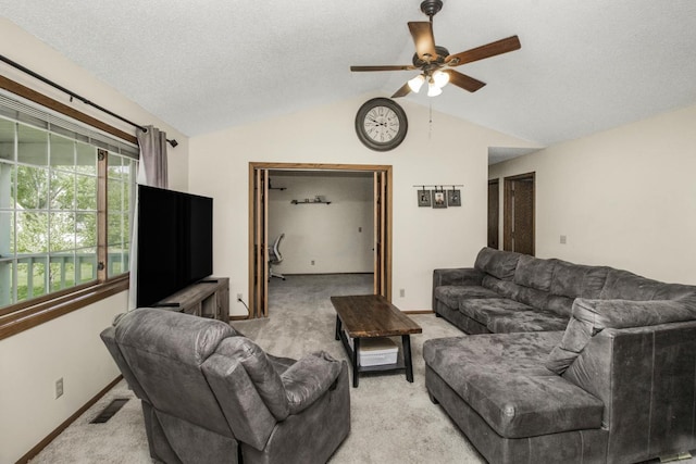 living room featuring light carpet, a textured ceiling, vaulted ceiling, and ceiling fan