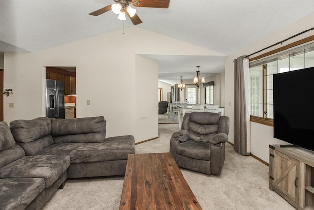 living room with plenty of natural light, lofted ceiling, and light carpet