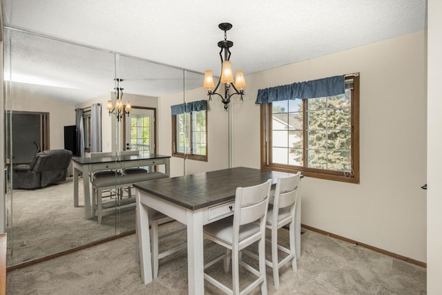 carpeted dining room with a textured ceiling and an inviting chandelier