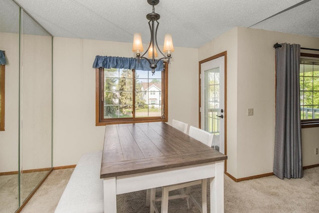 unfurnished dining area featuring light carpet, a textured ceiling, and a notable chandelier